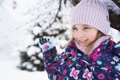 Portrait of smiling woman in snow