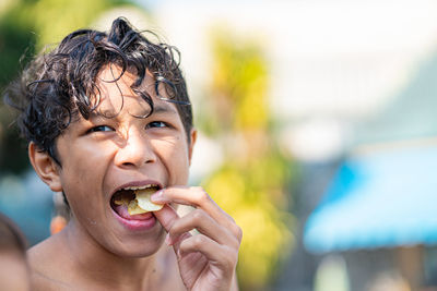 Portrait of boy eating food