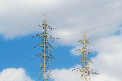 Low angle view of electricity pylon against sky