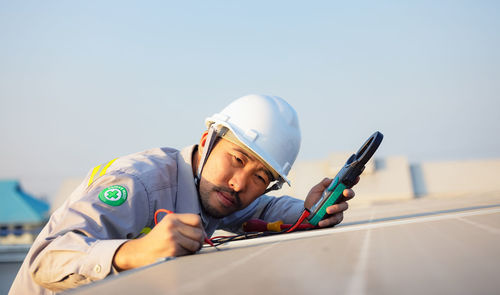 Engineer inspects solar panels on roof of modern house. alternative energy ecological concept.