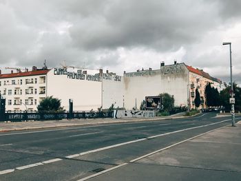 Road by city against sky