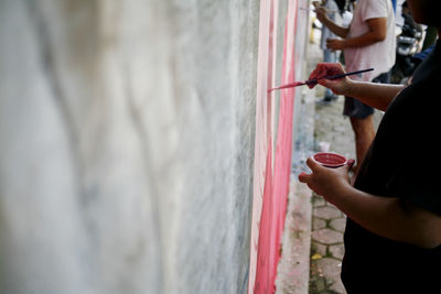 Artist hand drawing mural on the wall