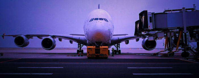 Panoramic shot of airplane at airport against sky