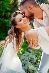 Portrait of bride grooming outdoors