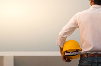 Rear view of man working at construction site