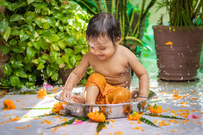 High angle view of boy sitting on table