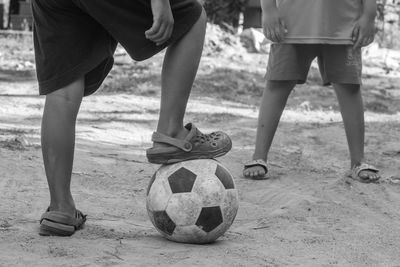 Low section of boys playing with soccer ball