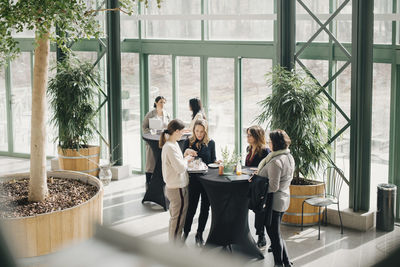 Confident female business professionals planning during meeting at event