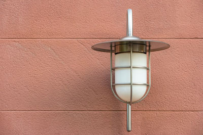 Low angle view of lamp hanging on wall