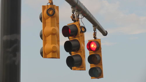 Low angle view of road sign against sky