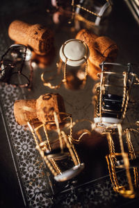 Assortment of cages and corks from bottles of sparkling wine on silver tray