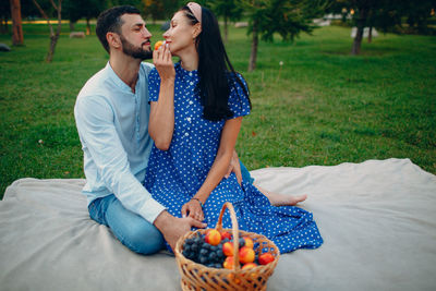 Young couple and woman eating food