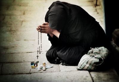 Woman kneeling on pavement