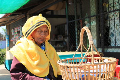 Senoir woman wearing a yellow winter cloth.