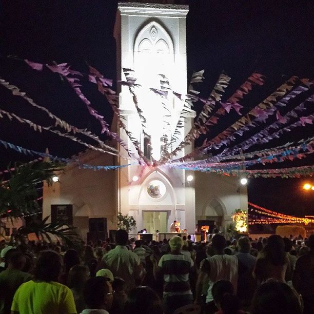 illuminated, night, architecture, built structure, large group of people, arts culture and entertainment, celebration, building exterior, religion, men, crowd, person, leisure activity, lighting equipment, lifestyles, decoration, place of worship, spirituality, low angle view