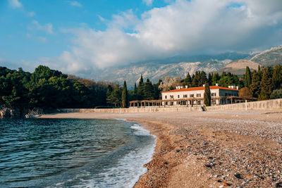 Scenic view of buildings and mountains against sky