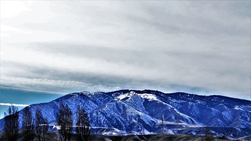 Scenic view of snowcapped mountains against sky