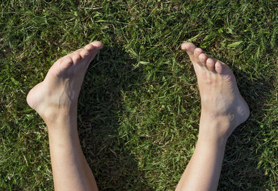 Low section of person legs on field