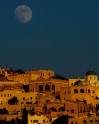 Buildings against blue sky at night