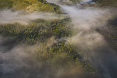 View from drone of incredible atmosphere with foggy hills at sunrise. 