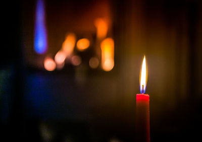 Close-up of lit candles in the dark