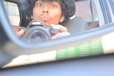 Close-up of young woman in car