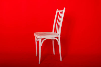Empty chairs against yellow background