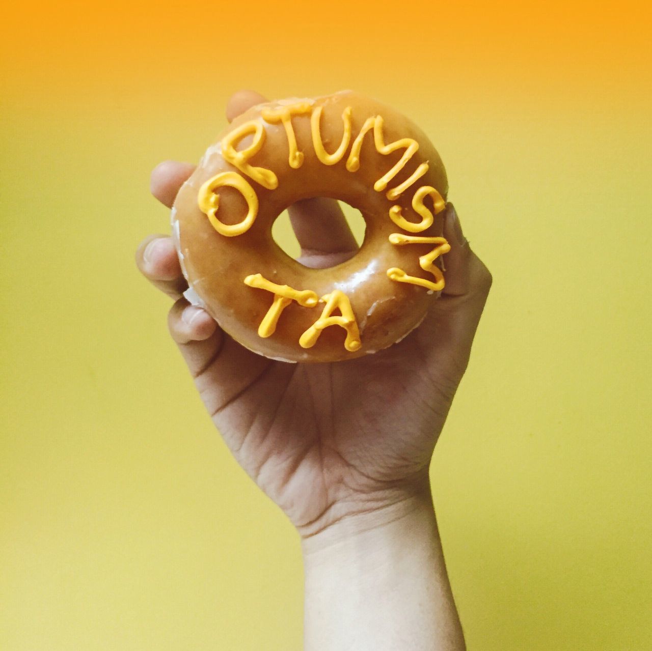 person, holding, sweet food, close-up, part of, human finger, indoors, cropped, food and drink, freshness, creativity, indulgence, dessert, unhealthy eating, yellow, unrecognizable person, studio shot