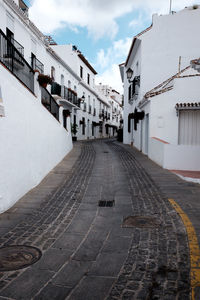 Empty alley amidst buildings in city