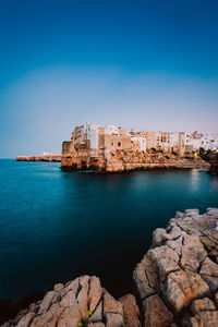 Scenic view of sea and buildings against sky