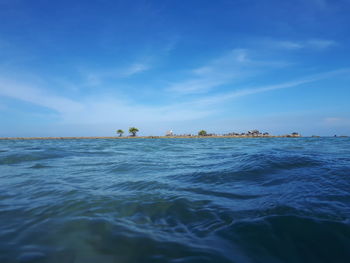 Scenic view of sea against blue sky