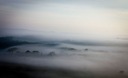 Scenic view of mountains against cloudy sky