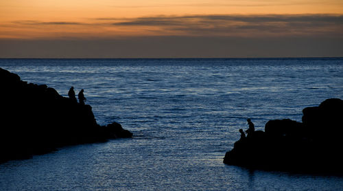 Scenic view of sea against sky at sunset