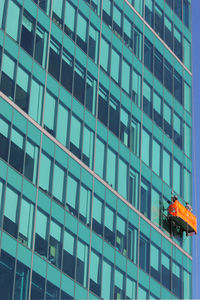 Low angle view of workers cleaning modern building