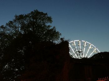 Low angle view of ferris wheel against sky at night