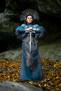Portrait of young woman standing in forest
