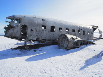 Abandoned airplane on snow covered landscape