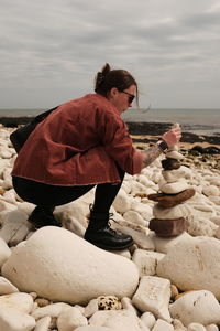 Rear view of woman standing against wall