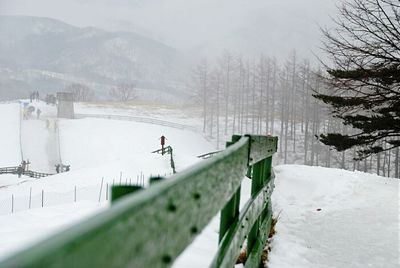 Man on snow covered landscape against sky