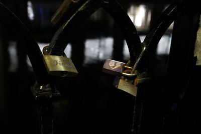 Close-up of padlocks hanging on metal