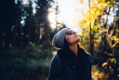 Woman in sunglasses in forest