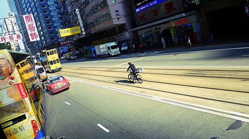 Man riding bicycle on road in city