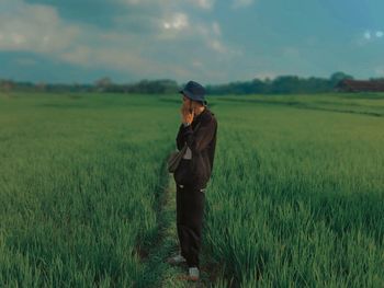 Full length of man standing in field