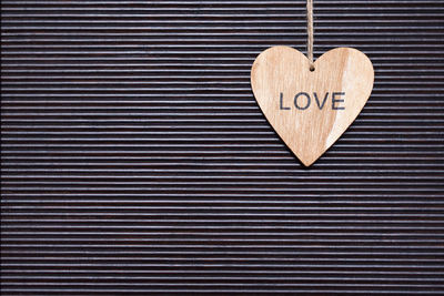 Close-up of heart shape text on wood