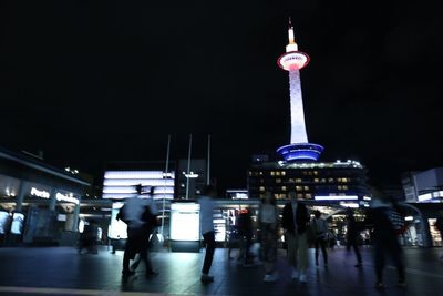 People on illuminated city at night