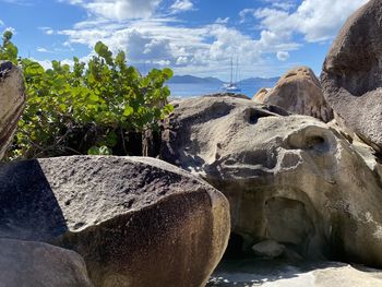 Rocks by sea against sky