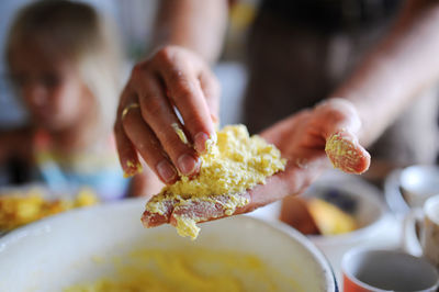 Cropped hand of person preparing food