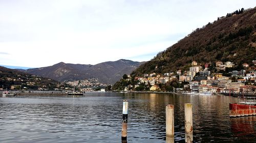 Scenic view of lake by buildings against sky