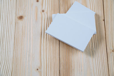 High angle view of white paper on wooden table