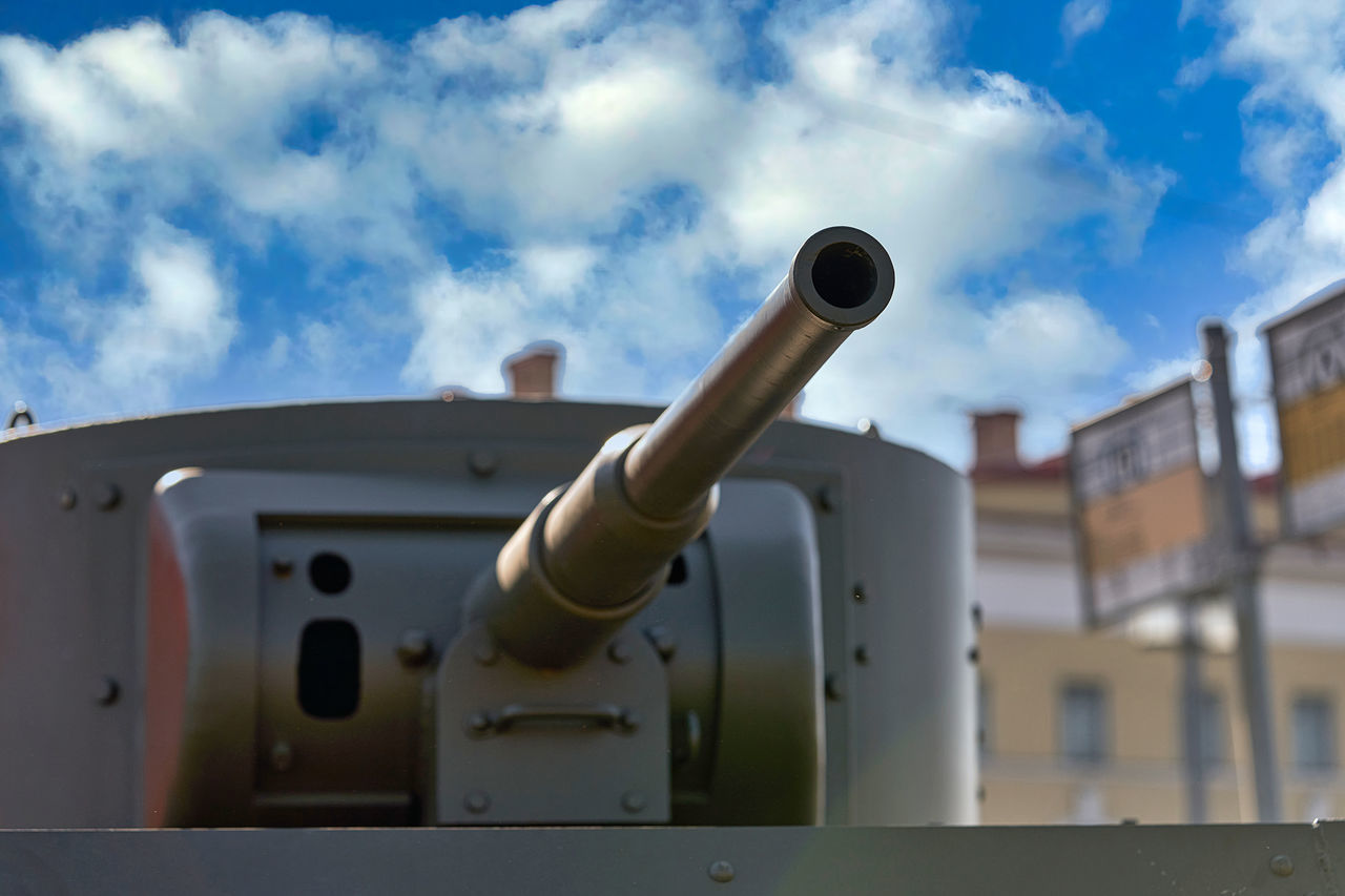 LOW ANGLE VIEW OF METAL BY BUILDING AGAINST SKY